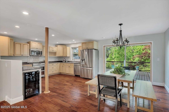 6 Maple Ter, Bethlehem, NY 12054 - kitchen featuring wine cooler, appliances with stainless steel finishes, cream cabinetry, a chandelier, and dark wood-type flooring