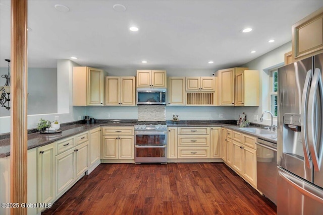 6 Maple Ter, Bethlehem, NY 12054 - kitchen with stainless steel appliances, dark wood-style flooring, dark countertops, cream cabinets, and recessed lighting