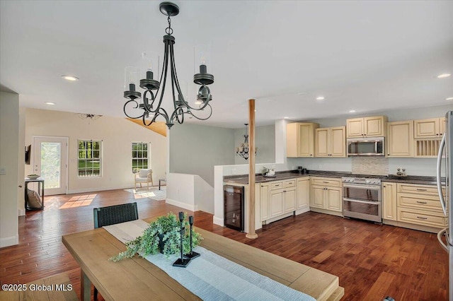 6 Maple Ter, Bethlehem, NY 12054 - kitchen featuring appliances with stainless steel finishes, cream cabinetry, wine cooler, dark countertops, and recessed lighting