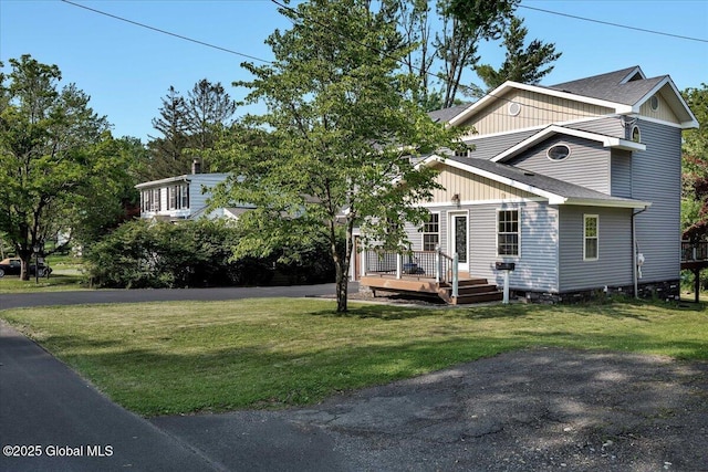 6 Maple Ter, Bethlehem, NY 12054 - view of front of house with a front yard, a wooden deck, and a shingled roof