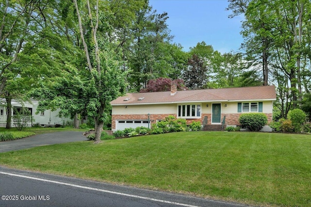 3083 E Old State Rd, Guilderland, NY 12303 - view of front of house with asphalt driveway, a front lawn, a chimney, and brick siding