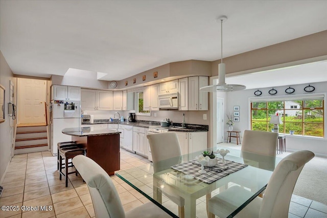 3083 E Old State Rd, Guilderland, NY 12303 - dining space with light tile patterned floors and stairway