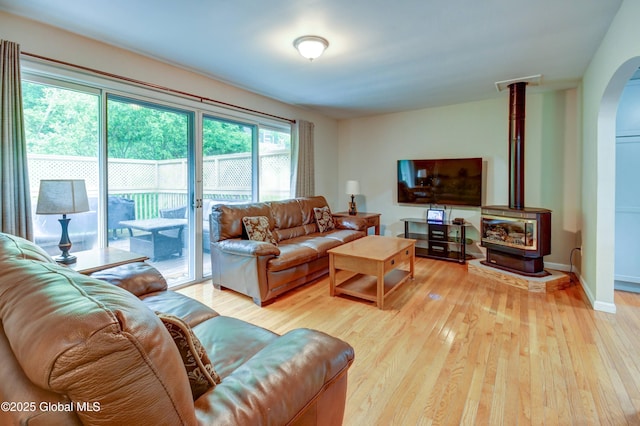 4 Tomohawk Pl, Johnstown, NY 12095 - living area with light wood-type flooring, a wood stove, and arched walkways