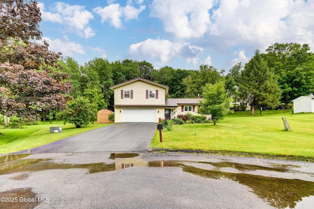 4 Tomohawk Pl, Johnstown, NY 12095 - tri-level home featuring an attached garage, asphalt driveway, and a front lawn