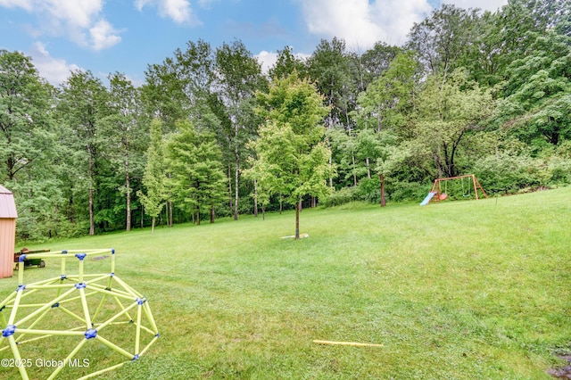 4 Tomohawk Pl, Johnstown, NY 12095 - view of grassy yard featuring a playground and a forest view
