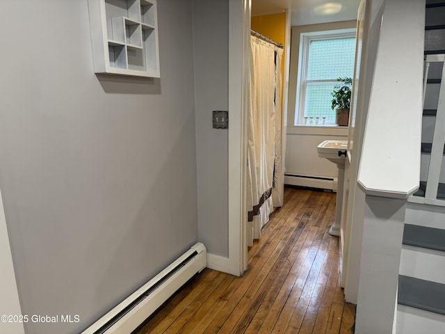3 Meacham St, Port Henry, NY 12974 - hallway featuring a baseboard heating unit, dark wood-style flooring, baseboard heating, and baseboards