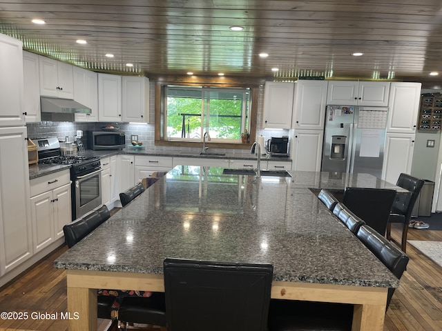 3 Meacham St, Port Henry, NY 12974 - kitchen with stainless steel appliances, a kitchen breakfast bar, dark wood-style floors, and white cabinetry