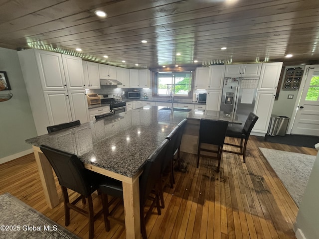 3 Meacham St, Port Henry, NY 12974 - kitchen featuring stainless steel appliances, dark wood-style floors, plenty of natural light, white cabinetry, and wooden ceiling