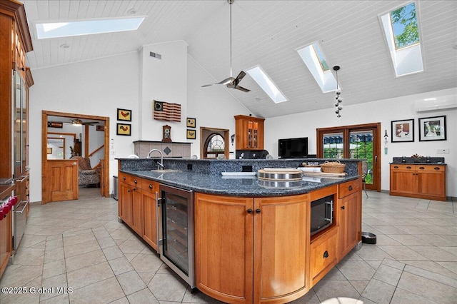 2034 Duanesburg Churches Rd, Duanesburg, NY 12053 - kitchen with a skylight, wine cooler, high vaulted ceiling, built in microwave, and light tile patterned floors