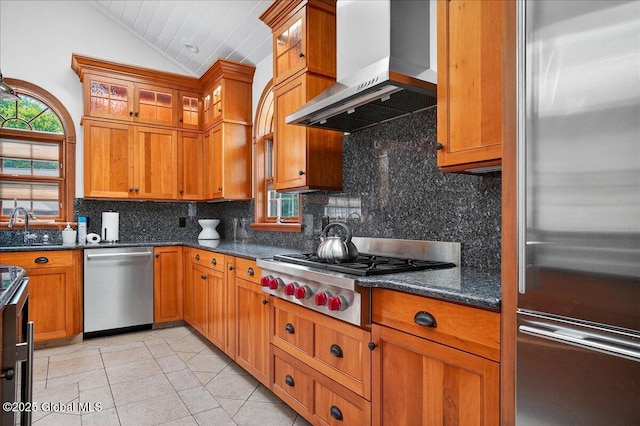 2034 Duanesburg Churches Rd, Duanesburg, NY 12053 - kitchen featuring stainless steel appliances, wall chimney exhaust hood, vaulted ceiling, decorative backsplash, and light tile patterned floors