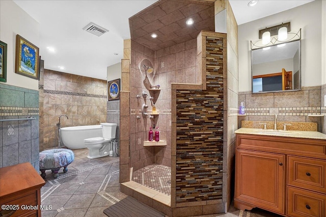 2034 Duanesburg Churches Rd, Duanesburg, NY 12053 - full bathroom with tile walls, tile patterned floors, vanity, walk in shower, and recessed lighting