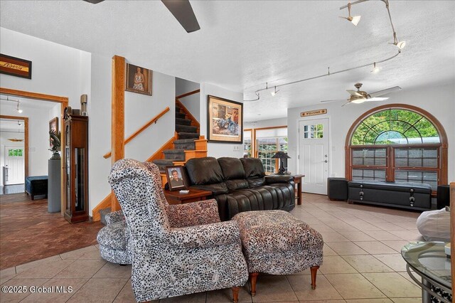 2034 Duanesburg Churches Rd, Duanesburg, NY 12053 - tiled living room with a ceiling fan, rail lighting, stairs, and a textured ceiling