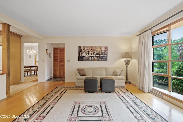 19 Tamarack Ln, Colonie, NY 12309 - living area with wood finished floors, a chandelier, and ornamental molding