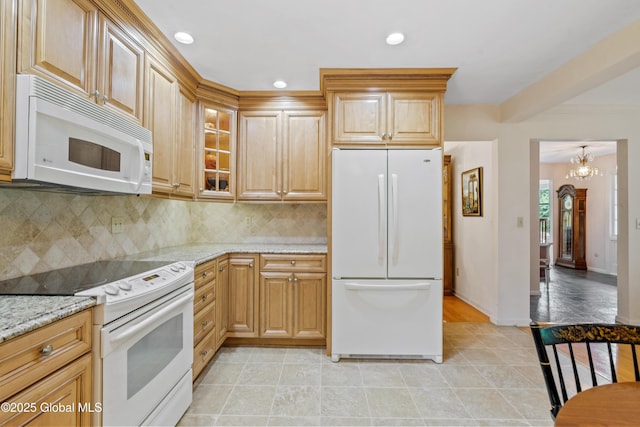 19 Tamarack Ln, Colonie, NY 12309 - kitchen featuring white appliances, light stone counters, tasteful backsplash, recessed lighting, and a chandelier