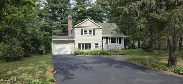 7 Patten Dr, Colonie, NY 12211 - view of front of home featuring asphalt driveway, a garage, a chimney, a front lawn, and roof with shingles