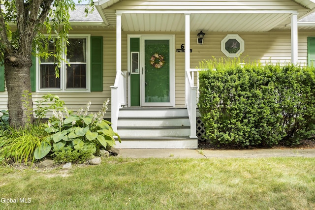 67 Victoria Way, Albany, NY 12209 - property entrance with a shingled roof and a lawn