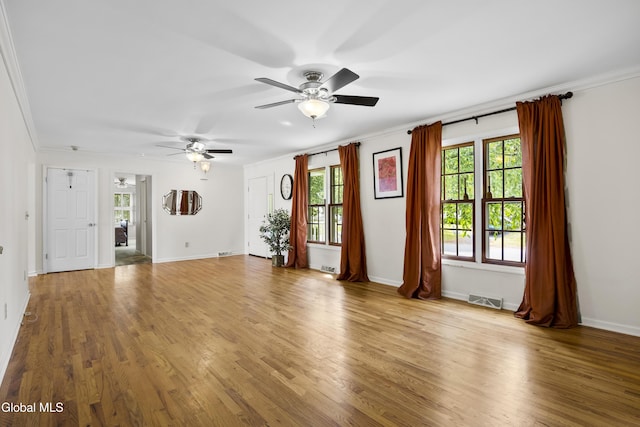 67 Victoria Way, Albany, NY 12209 - unfurnished living room with a ceiling fan, crown molding, plenty of natural light, and wood finished floors