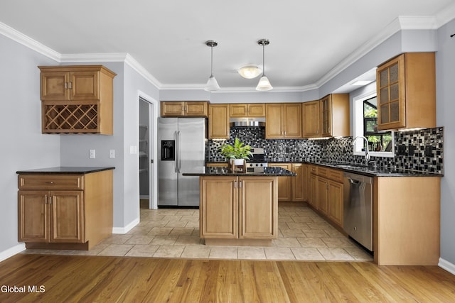 67 Victoria Way, Albany, NY 12209 - kitchen with stainless steel appliances, under cabinet range hood, decorative backsplash, a kitchen island, and glass insert cabinets