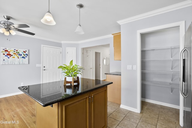67 Victoria Way, Albany, NY 12209 - kitchen featuring ceiling fan, decorative light fixtures, a kitchen island, crown molding, and dark stone counters