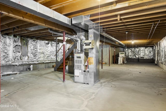 67 Victoria Way, Albany, NY 12209 - unfinished below grade area with electric panel, heating unit, and stairway