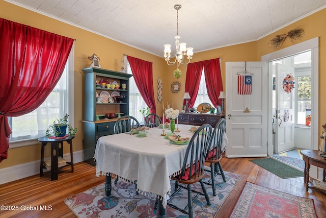 7 Bruce St, Scotia, NY 12302 - dining room featuring ornamental molding, a chandelier, wood-type flooring, and healthy amount of natural light