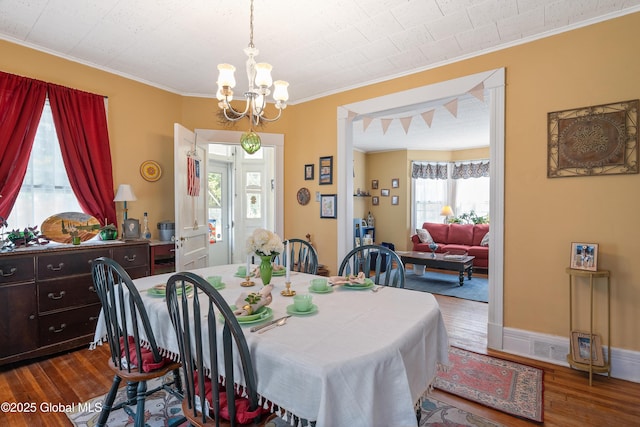 7 Bruce St, Scotia, NY 12302 - dining space with a chandelier, ornamental molding, dark wood-style flooring, and healthy amount of natural light