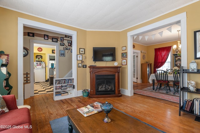 7 Bruce St, Scotia, NY 12302 - living room with ornamental molding, wood-type flooring, a chandelier, and a fireplace