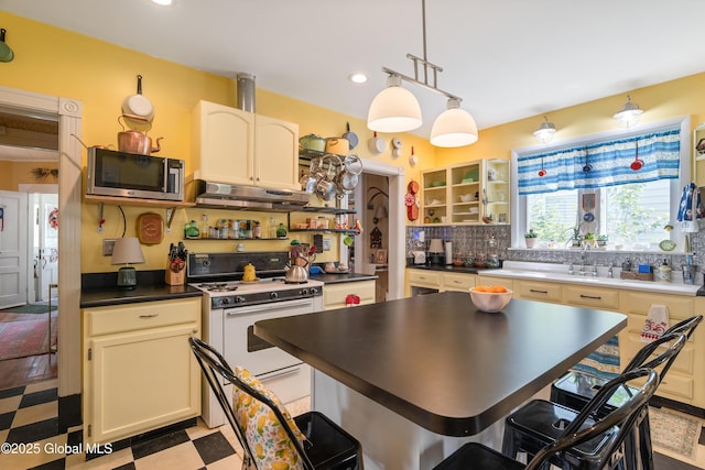 7 Bruce St, Scotia, NY 12302 - kitchen featuring white range with gas cooktop, stainless steel microwave, open shelves, exhaust hood, and dark countertops