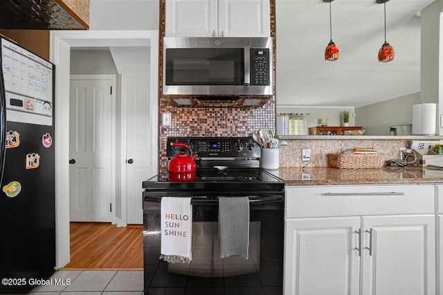 47 Mountainview Ter, North Greenbush, NY 12144 - kitchen with black appliances, white cabinets, tasteful backsplash, light tile patterned floors, and light stone countertops