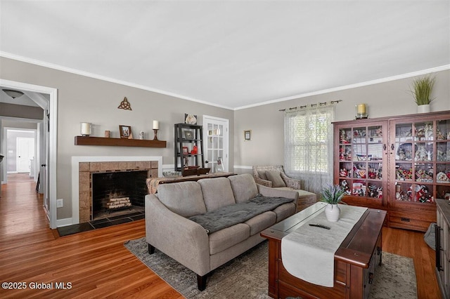 47 Mountainview Ter, North Greenbush, NY 12144 - living area featuring wood finished floors, crown molding, and a tile fireplace