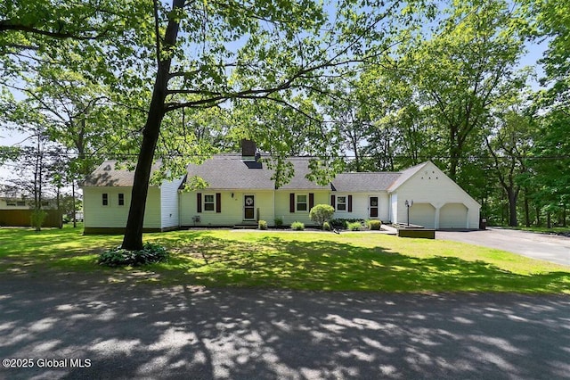 47 Mountainview Ter, North Greenbush, NY 12144 - view of front of house with asphalt driveway, a garage, a front yard, and a chimney