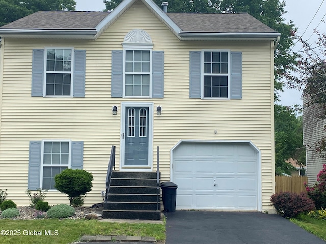 485 Chadwick Rd, Schenectady, NY 12304 - view of front of house with a garage, entry steps, a shingled roof, and driveway