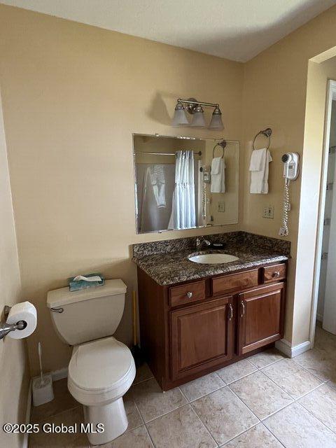 3014 Lake Shore Dr Unit 17D, Lake George, NY 12845 - full bath with vanity, toilet, tile patterned flooring, and a shower with curtain