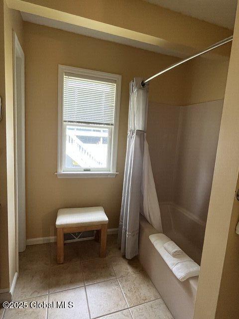 3014 Lake Shore Dr Unit 17D, Lake George, NY 12845 - bathroom featuring shower / bath combo with shower curtain and tile patterned floors