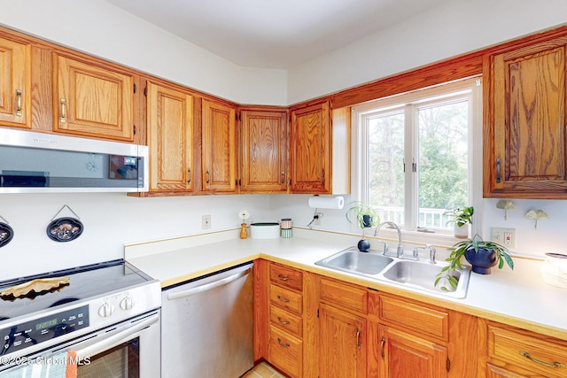 9 Arlene Ave, Guilderland, NY 12203 - kitchen with stainless steel appliances, light countertops, and brown cabinetry