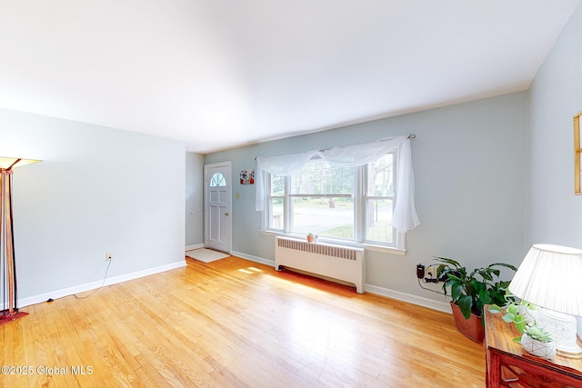 9 Arlene Ave, Guilderland, NY 12203 - unfurnished living room with radiator and light wood finished floors