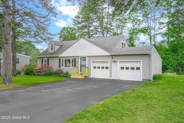 9 Arlene Ave, Guilderland, NY 12203 - view of front of property featuring a garage, driveway, a front yard, and a shingled roof