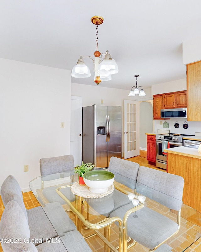 9 Arlene Ave, Guilderland, NY 12203 - dining area with baseboards and a chandelier