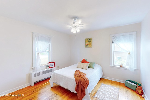 9 Arlene Ave, Guilderland, NY 12203 - bedroom featuring radiator heating unit, multiple windows, light wood finished floors, and ceiling fan