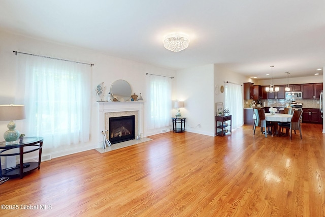 113 Fieldstone Dr, Niskayuna, NY 12304 - living room featuring a fireplace with flush hearth and light wood-style flooring