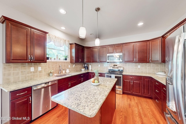 113 Fieldstone Dr, Niskayuna, NY 12304 - kitchen with stainless steel appliances, light wood finished floors, hanging light fixtures, a kitchen island, and recessed lighting