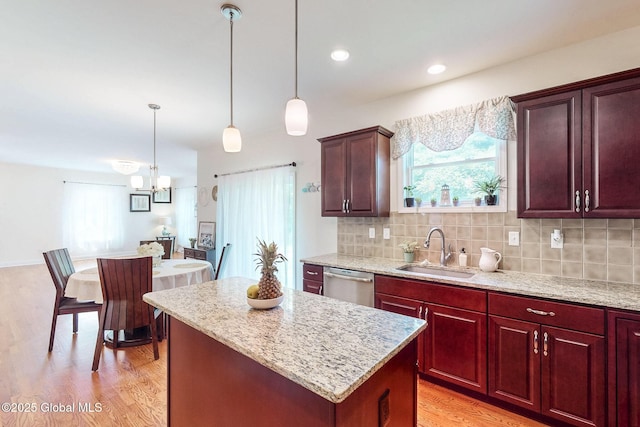 113 Fieldstone Dr, Niskayuna, NY 12304 - kitchen featuring stainless steel dishwasher, light wood finished floors, a chandelier, a center island, and hanging light fixtures