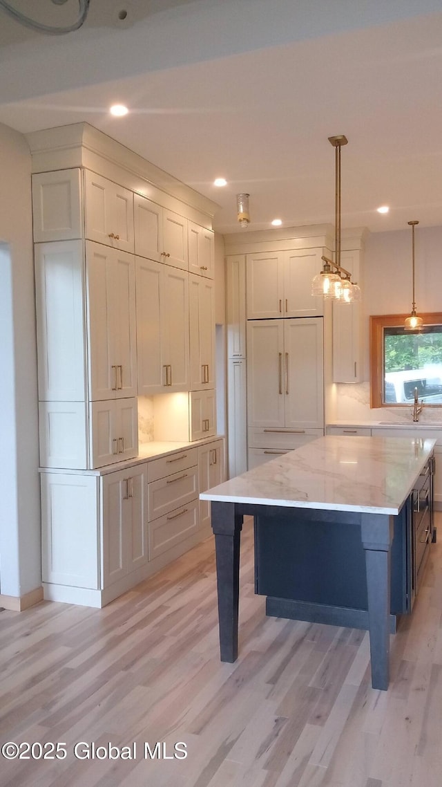 101 W High St, Ballston Spa, NY 12020 - kitchen featuring light wood-style floors, pendant lighting, recessed lighting, light stone countertops, and backsplash