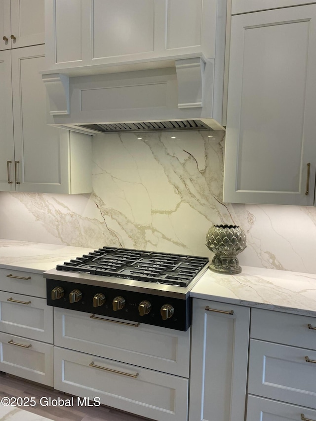 101 W High St, Ballston Spa, NY 12020 - kitchen featuring cooktop, backsplash, premium range hood, and light stone counters