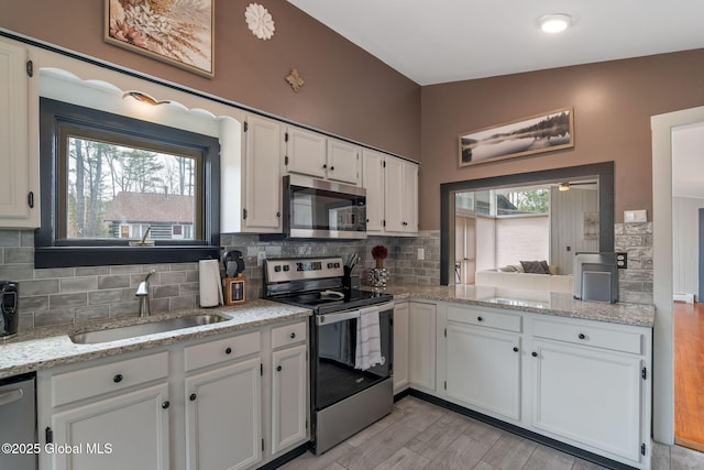 4A High Pines Ter, Warrensburg, NY 12817 - kitchen featuring appliances with stainless steel finishes, white cabinetry, and decorative backsplash
