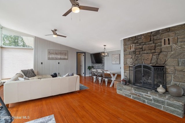 4A High Pines Ter, Warrensburg, NY 12817 - living area featuring vaulted ceiling, a ceiling fan, wood finished floors, and a stone fireplace