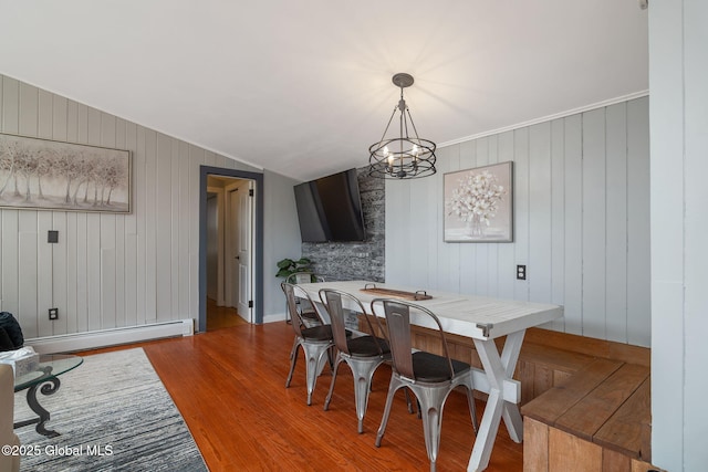 4A High Pines Ter, Warrensburg, NY 12817 - dining space featuring a baseboard radiator, wood finished floors, a chandelier, and wooden walls
