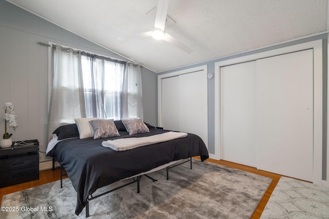 4A High Pines Ter, Warrensburg, NY 12817 - bedroom featuring vaulted ceiling, multiple closets, wood finished floors, a textured ceiling, and ceiling fan