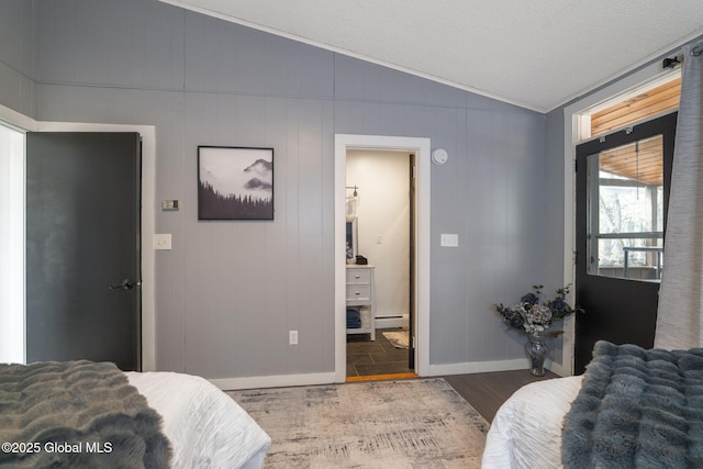 4A High Pines Ter, Warrensburg, NY 12817 - bedroom featuring vaulted ceiling, baseboard heating, and wood finished floors