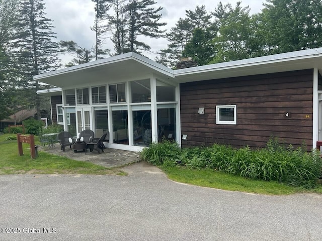 4A High Pines Ter, Warrensburg, NY 12817 - rear view of house featuring a patio and a fire pit